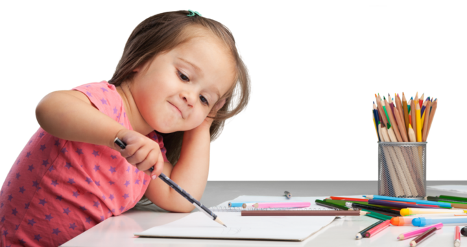 Cute little girl doing homework,writing and painting.