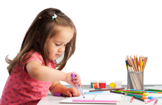 Cute little girl doing homework,writing and painting.