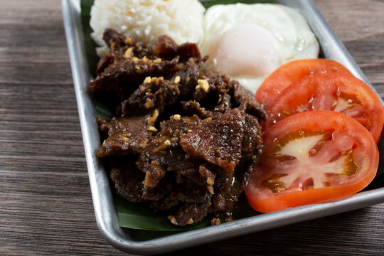 A view of a tray of beef tapsilog.