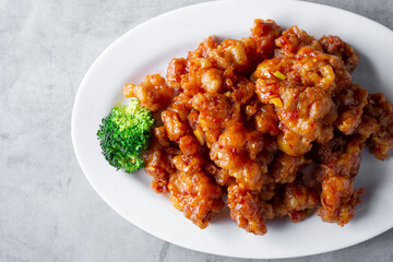A top down view of a plate of orange chicken.