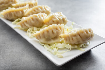 A view of a plate of steamed jiaozi.