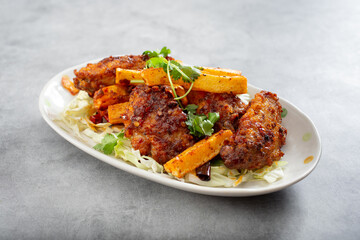 A view of a plate of Asian spicy chicken wings.