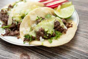A closeup view of a plate of carne asada street tacos.