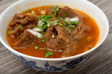 A closeup view of a bowl of beef birria soup.