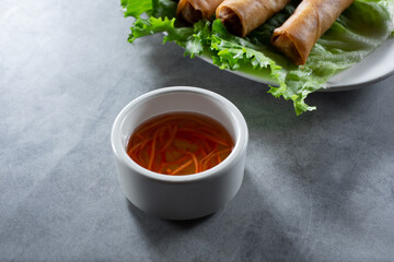 A view of a condiment cup of nuoc cham.