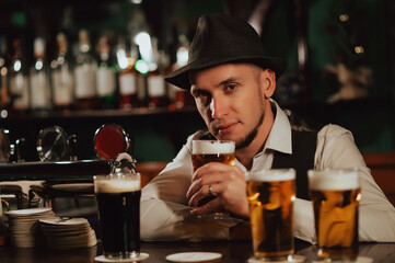 bartender at bar counter tasting various varieties of craft beer in pub