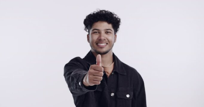 Face, happy and thumbs up of man in studio isolated on a white background. Portrait, like hand gesture and male person with emoji for agreement, success or excellence, ok and thank you for mockup.