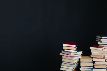 a stack of books in the library on a black background training education science