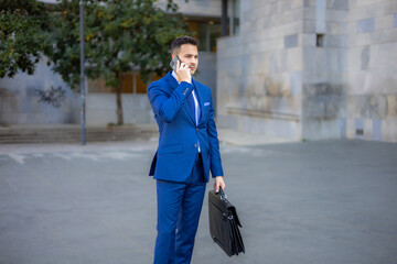 Young business man wearing a modern suit and briefcase out of office. Isolated handsome economist,...
