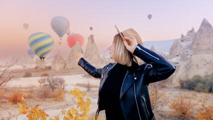 Traveler woman background landscape Cappadocia with hot air balloons sun light. Concept trip Turkey travel