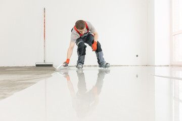 Screed concrete with self leveling cement mortar for floors. Master work renovation home
