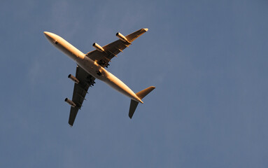 Approaching plane against a clear sky in the evening hours in Lisbon, Portugal