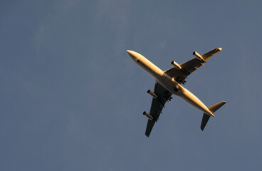 Approaching plane against a clear sky in the evening hours in Lisbon, Portugal