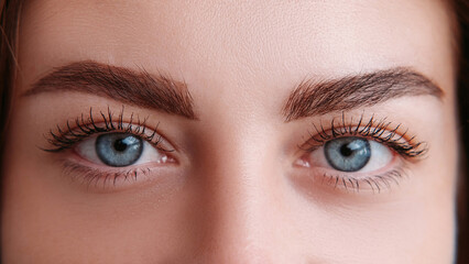 Ophthalmology check. Female blue eyes. Macro view. Unrecognizable woman with wide opened look closeup.