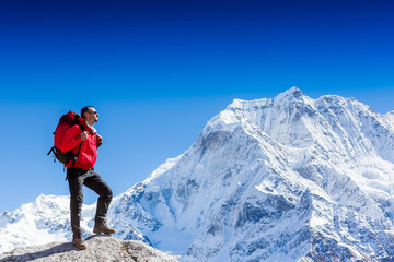 Hiker on the top in Himalayas mountains. Travel sport lifestyle concept