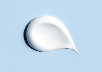 cosmetic smears of creamy texture on blue background