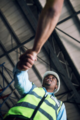 Black man, architect and handshake for construction, building or hiring in teamwork partnership on...