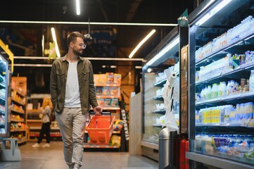 Handsome man shopping in a supermarket