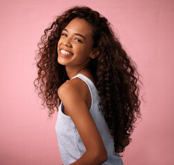 Hair care, portrait and woman in a studio with a natural, long and curly beauty salon hairstyle....