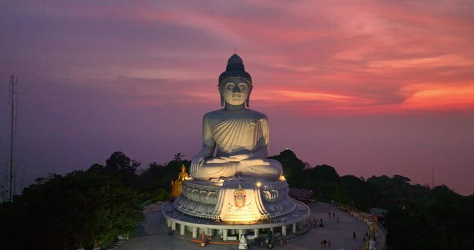 .aerial magnificent view of pink clouds illuminated by the setting sun created an awe-inspiring atmosphere. .The silhouette of the Big Buddha against the backdrop of the sky was truly breathtaking. .