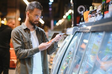 Handsome man shopping in a supermarket