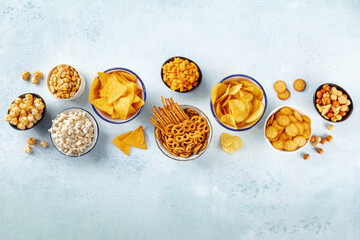 Salty snacks, party mix. An assortment of crispy appetizers, shot from above on a slate background...