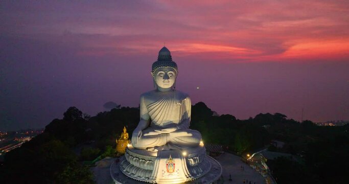 .aerial magnificent view of pink clouds illuminated by the setting sun created an awe-inspiring atmosphere. .The silhouette of the Big Buddha against the backdrop of the sky was truly breathtaking. .