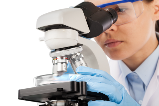 Young scientist doing research and looking through a microscope in a laboratory.