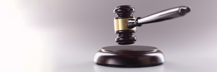 Brown wooden judge gavel in air closeup. Law justice or auction sale concept
