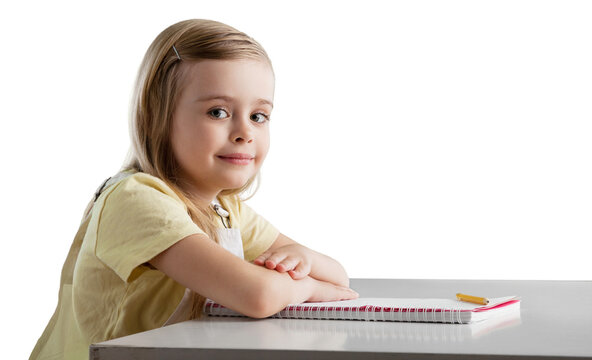 Cute little child girl writing at home.