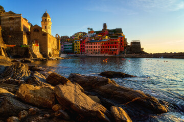 Scenic view of Vernazza village in Cinque Terre National Park, beautiful cityscape with colorful houses, sea and a harbor at sunset, Liguria region of Italy. Outdoor travel background