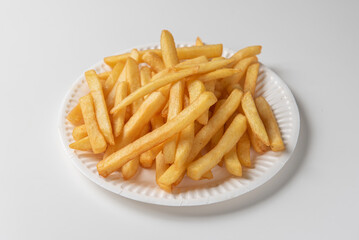 plate of French fries isolated on neutral white background in close up natural light 