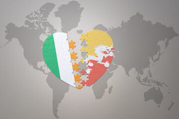 puzzle heart with the national flag of bhutan and ireland on a world map background.Concept.