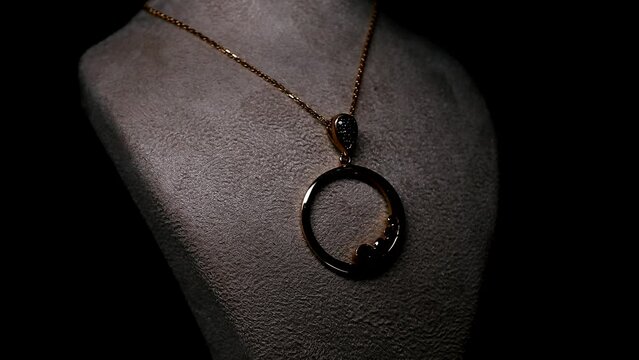 Gold necklace on the Revolving Platform black background jewelry gift gem quality valuable accessories