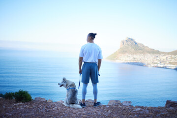 Nature, lake and man with dog in mountain for hiking, walking and fresh air together outdoors....