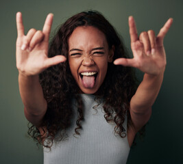 Female person, hand and rock in green studio background to celebrate with tongue in africa. Woman,...