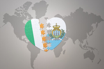 puzzle heart with the national flag of san marino and ireland on a world map background.Concept.