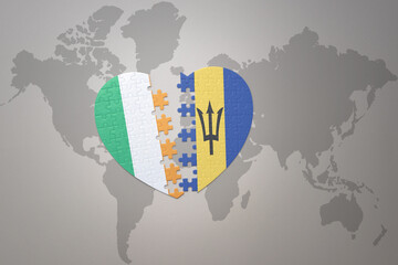 puzzle heart with the national flag of barbados and ireland on a world map background.Concept.