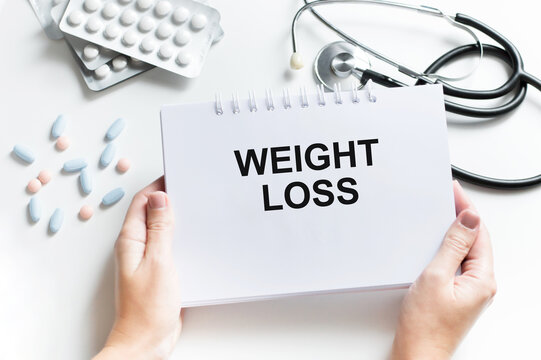 Weight Loss card in hands of Medical Doctor