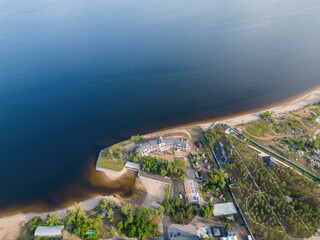 View of the peninsula with a large sandy beach and holiday houses from a bird's-eye view. A place for summer holidays by the sea. Sea trip