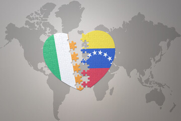 puzzle heart with the national flag of venezuela and ireland on a world map background.Concept.
