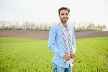 worry less ,indian farmer standing in his healthy wheat field
