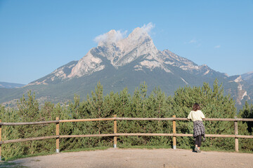 Fototapeta na wymiar Tourist woman watching Pedraforca Mountain, Pre-Pyrenees, Catalonia, Spain