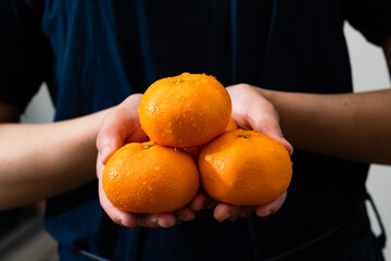 person holding oranges
