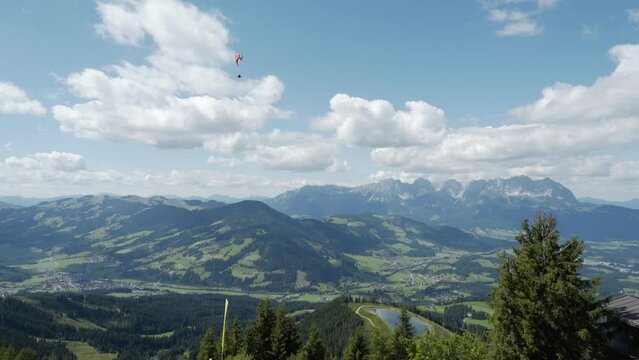 Parasailer Glides Through Summer Mountains in Austrian Alps