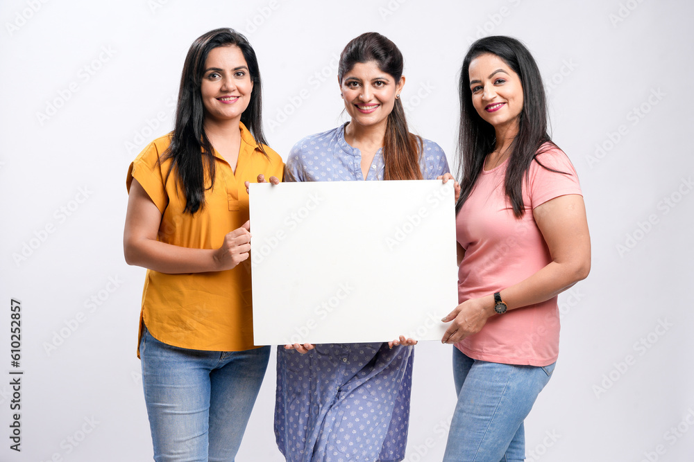 Wall mural indian women showing white board with copy space on white background.