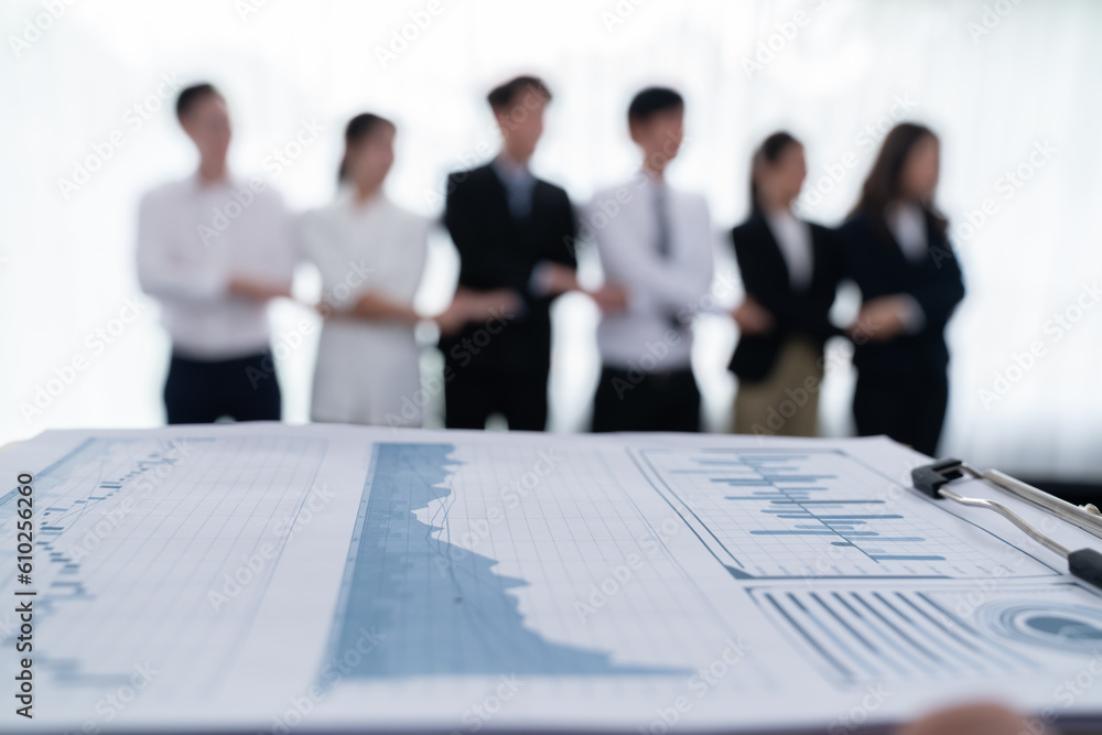 Poster closeup focus on financial report, performance result papers in front of camera with blur background