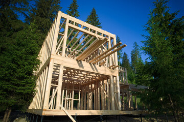 Drone's vantage point offers view of two-storey wooden-framed domicile in process of construction...