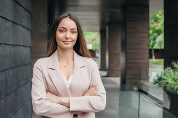business woman with folded hands on the background of an office building