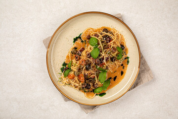 Portion of gourmet pasta spaghetti with kalamata olives